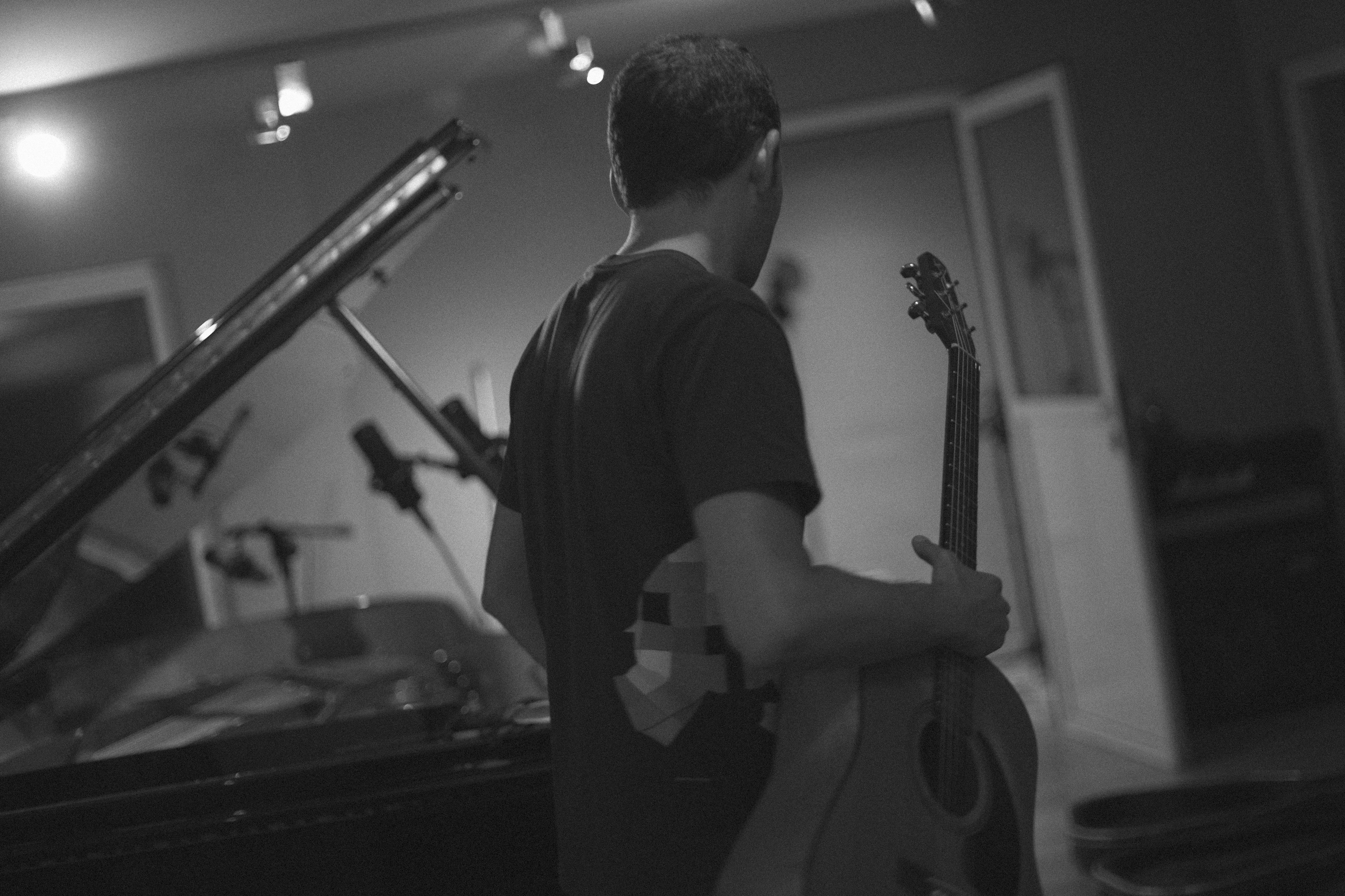 Pablo Pareja holding a guitar at a recording studio